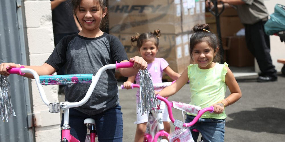 3 little girls with their bikes