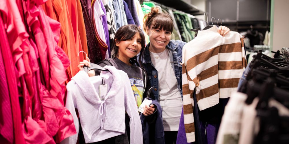 Volunteer helping a girl at a self-esteem building shopping spree