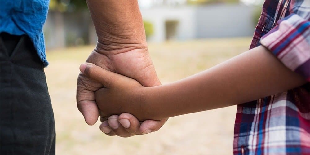 father and son holding hands