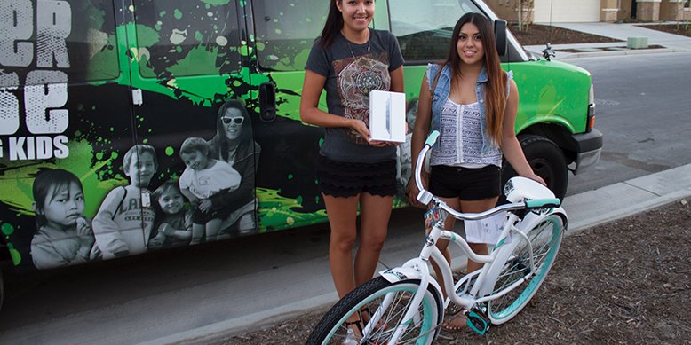 two young women with bike