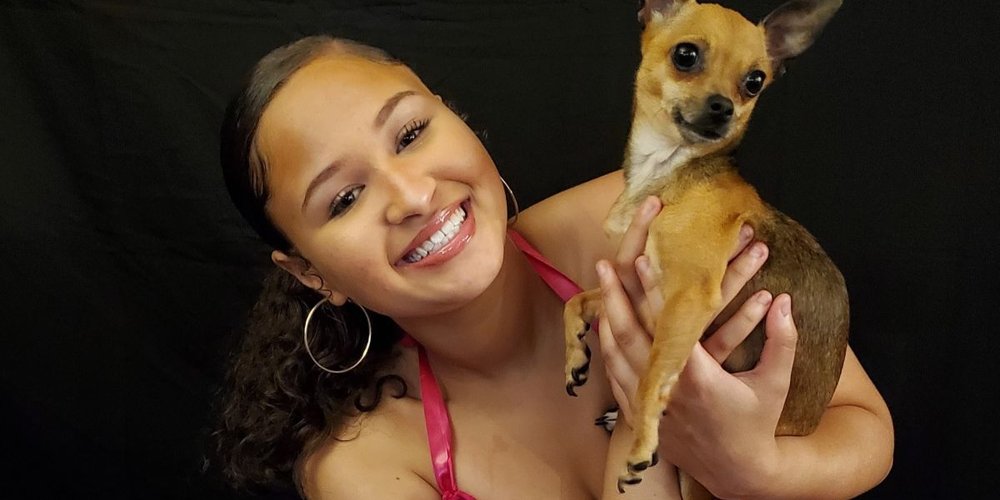 young woman holding a puppy