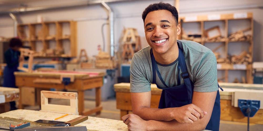 Young guy smiling because he got the brandsource scholarship!