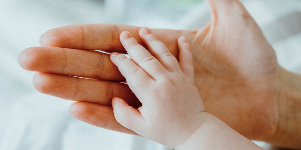 Cute_newborn_baby_holding_mother