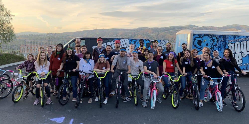 group of people and their bikes for team building benefits event