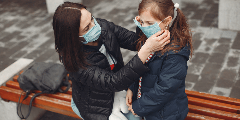 mother and daughter wearing facemask