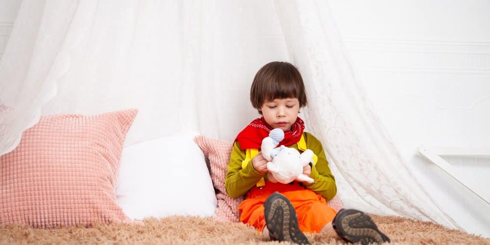 Boy sitting on bed