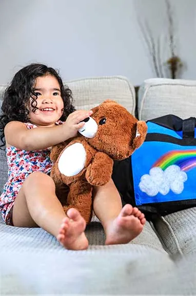 girl with sweet case sitting on couch