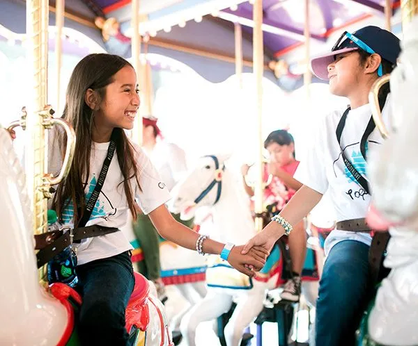 girls on carousel at disneyland