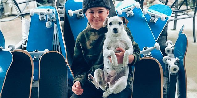 young boy carrying a cute dog