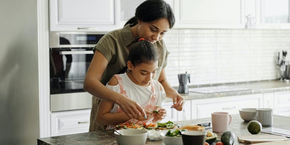 mother and daughter preparing food