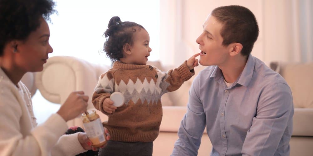 toddler with her mom and dad benefits from the Senator Gillibrand Foster Care Reform Bill