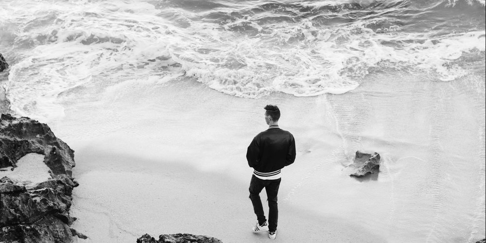 man walking by the sea