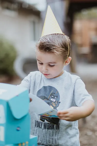 boy opening a birthday box