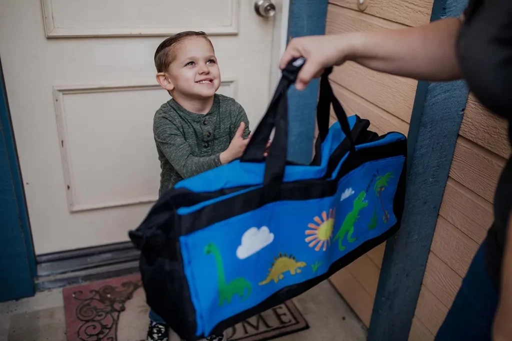 volunteer giving sweet case to kid