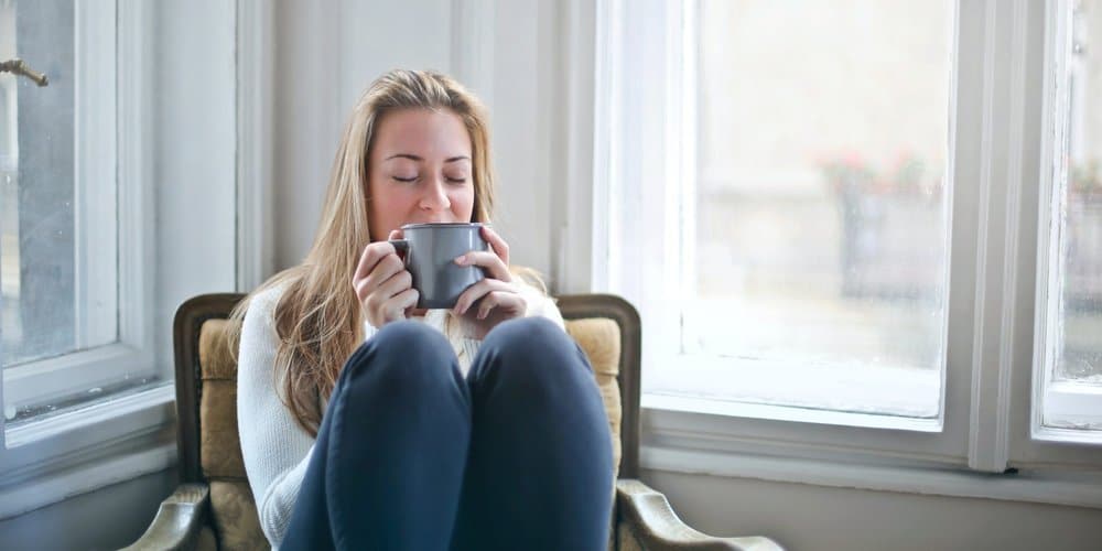 woman-holding-gray-ceramic-mug