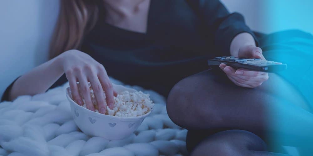 woman-in-white-bed-holding-remote