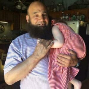 Mohamed holding a child