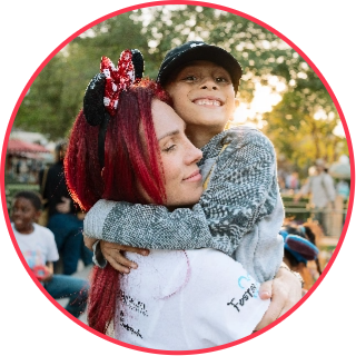 Disney Days volunteer hugging a child