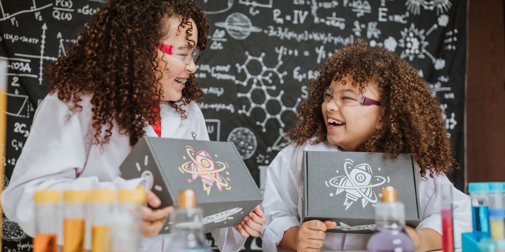 two girls opening their stem boxes
