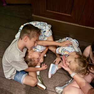 Levi and his sisters resting in line