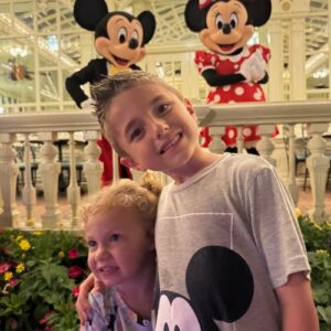 Levi and his sister with Mickey and Minnie Mouse