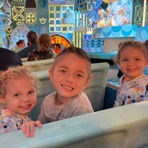Levi with his sister on It's a Small World in Disney World