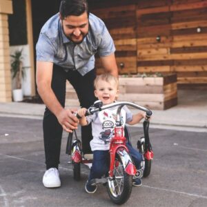 Man helping a child ride his first bike