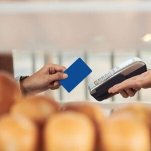 hand holding EBT card, about to swipe to pay for groceries