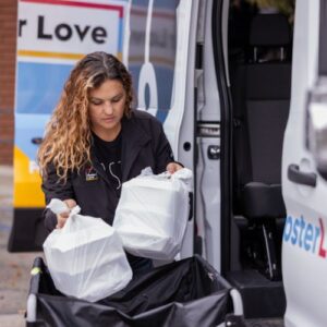 woman holding bags of donated food