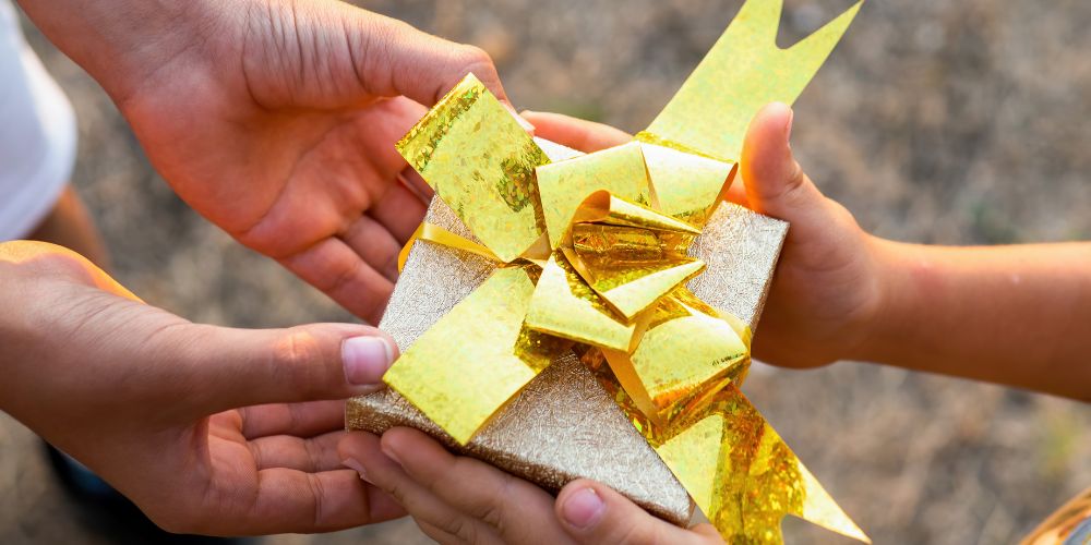 perfect adoption gift wrapped in a box with a golden bow