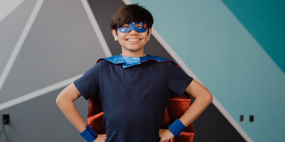 child in a superhero costume from his Superhero Box