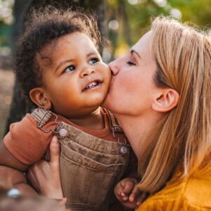 woman kissing her foster child on the cheek