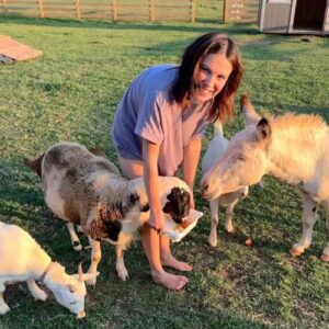 Millie on her farm interacting with barn animals