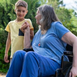 Grandparent in a wheelchair looking at her grandson
