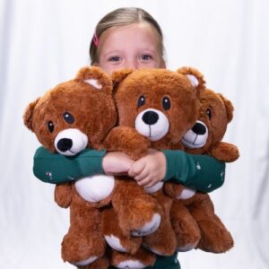 girl holding 3 foster love teddybears