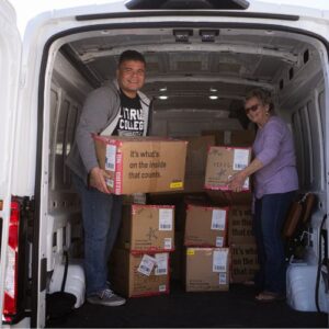 Two volunteers dropping off in-kind donations
