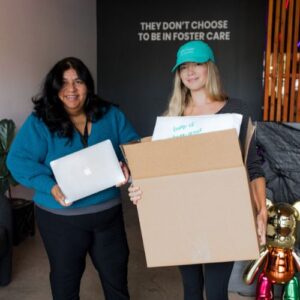 volunteers holding boxes of donations at Foster Love HQ