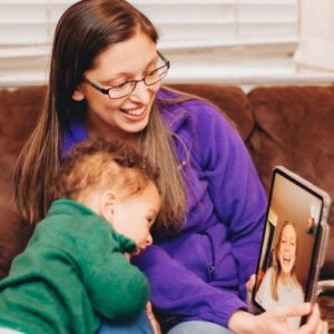 child talking to birth mom over video chat