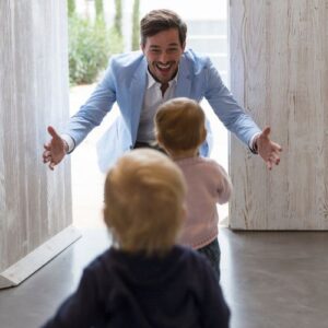 Father greeting toddlers with open arms