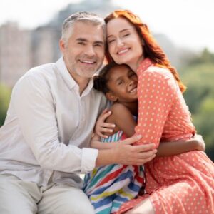 foster parents hugging their daughter