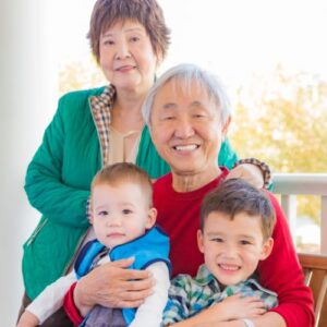 two grandparents holding their grandsons