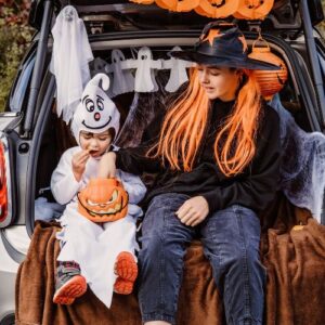 woman and child sitting in car for trunk or treat