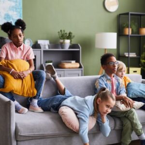 Kids relaxing on a couch in a group home