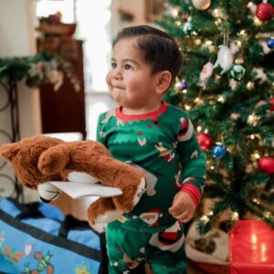 Child receiving his Holiday Foster Love Box on Christmas morning