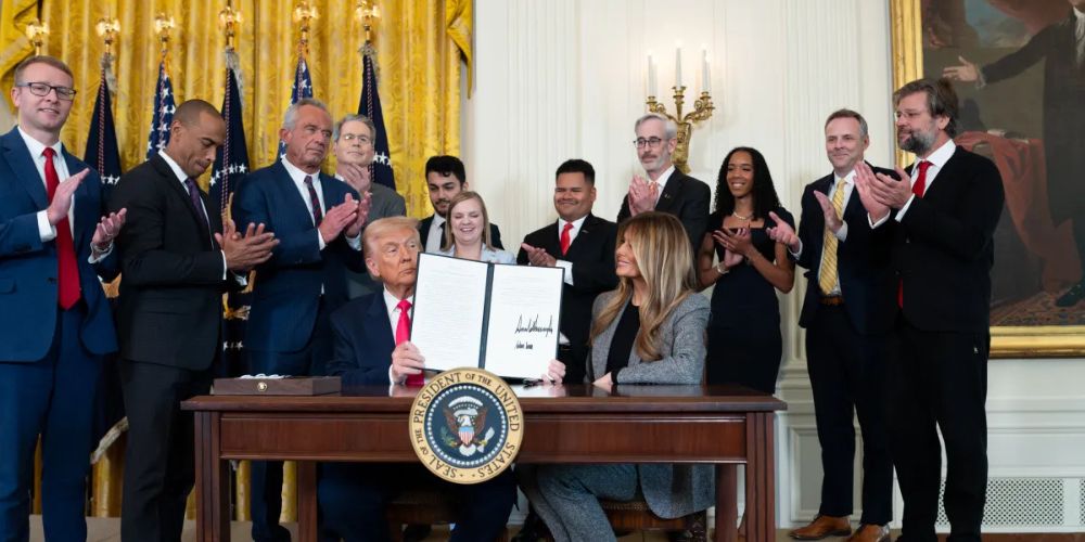 President Trump and Melania signing Fostering the Future Order