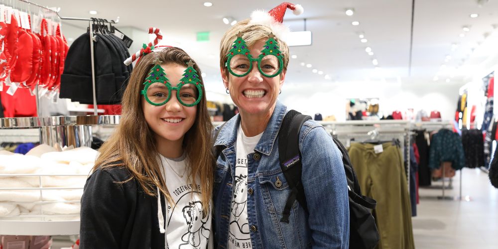 A volunteer at a holiday shopping for foster kids