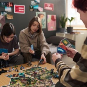 Three teens playing a board game
