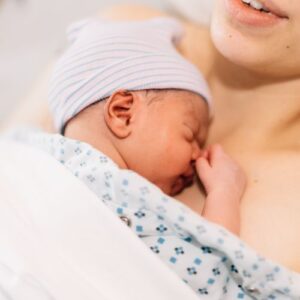 woman with a newborn baby on her chest