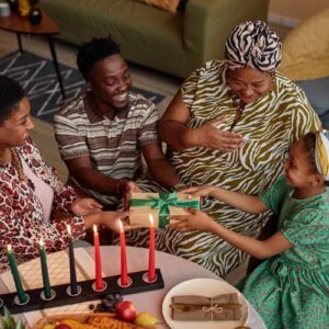 a family gathering and passing presents around for kwanzaa