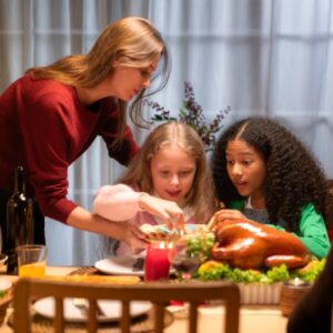 family sharing holiday dinner with foster kids
